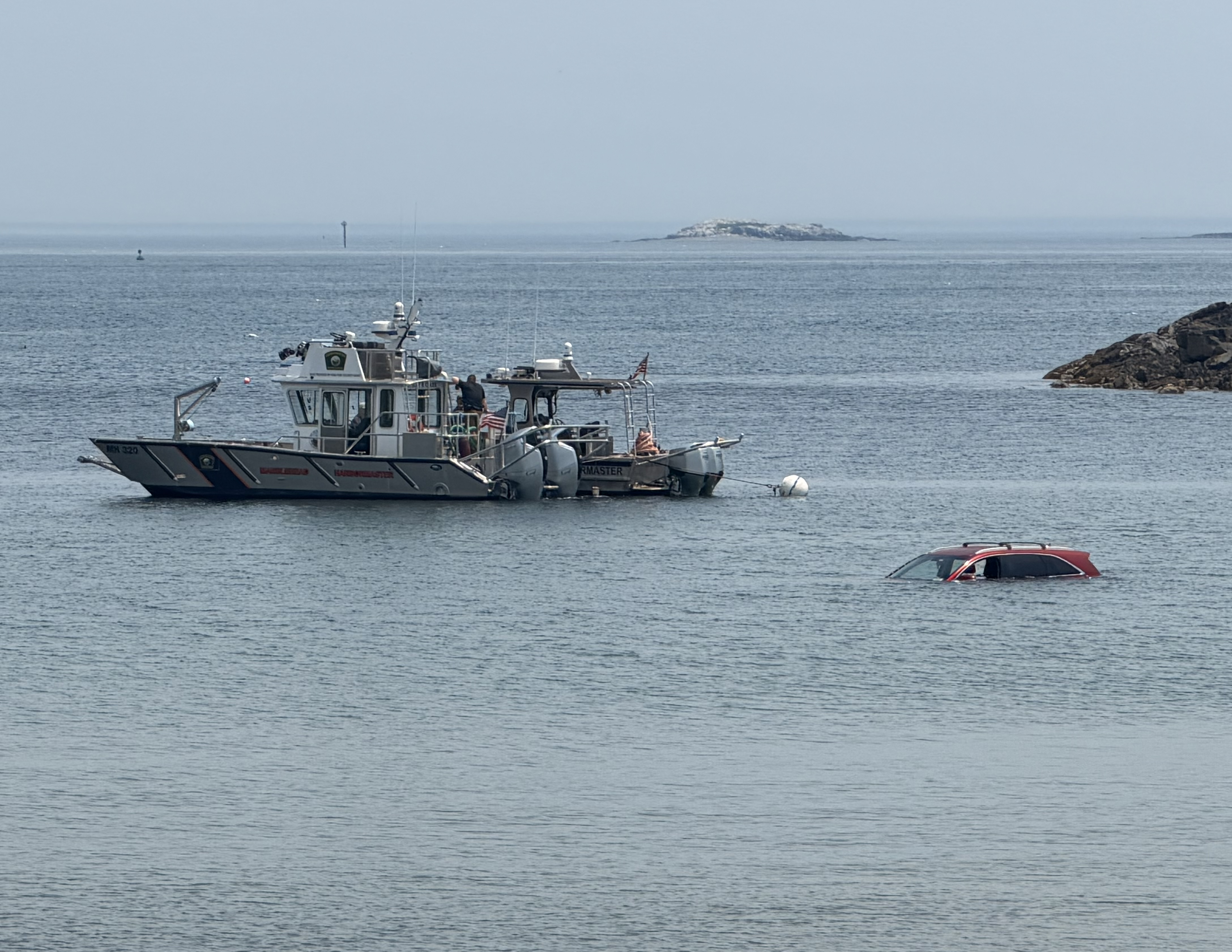 UPDATE 14:55. A red SUV partially submerged off Grace Oliver’s Beach was returned to shore after hours of work by Marblehead police, the Salem police dive team and others. The New York-plated vehicle was first seen in the water at 11:10. Preliminary investigation found no one inside.